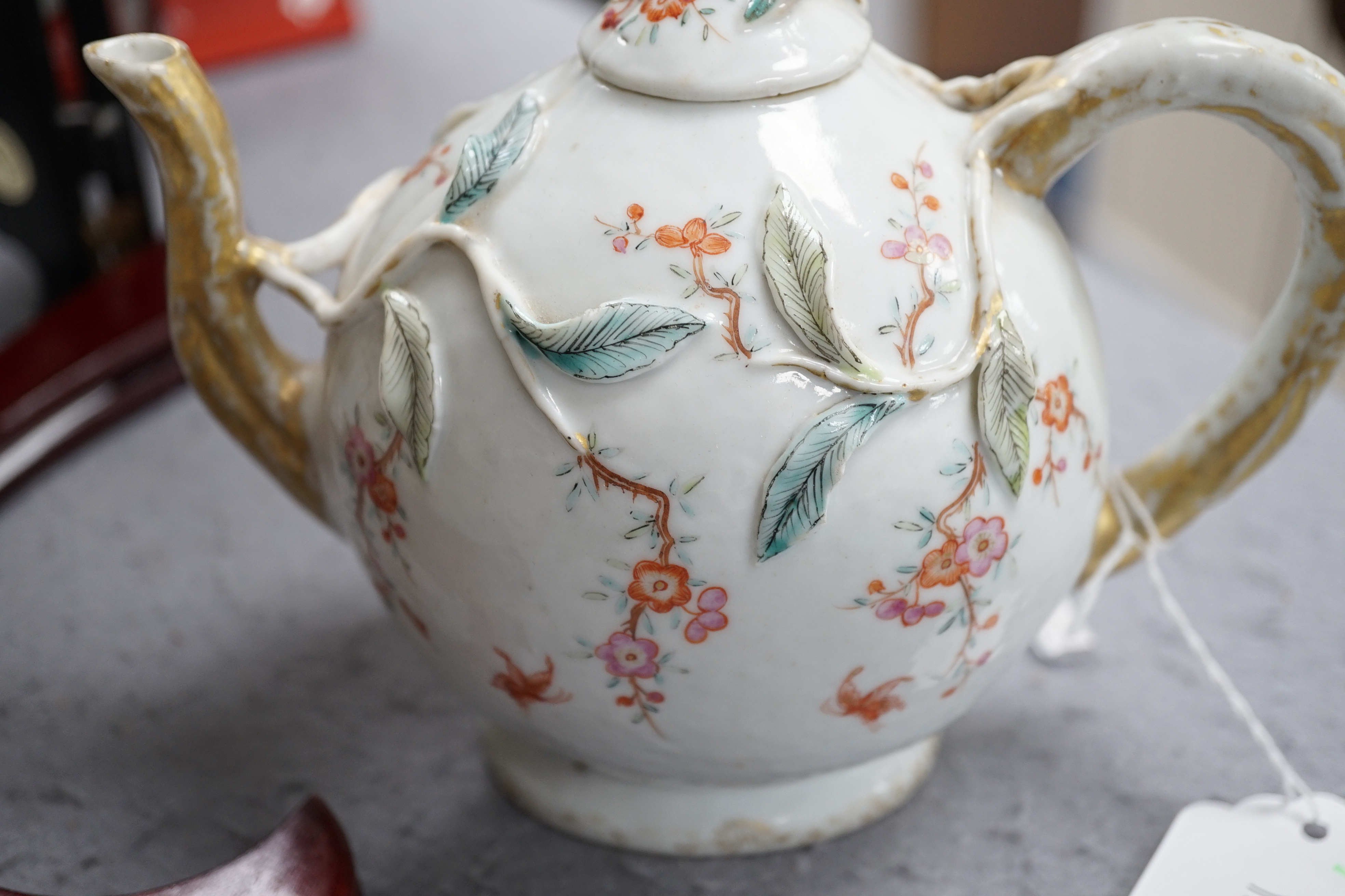 A Chinese enamelled porcelain peach-shaped teapot, Qianlong period (1736-95), wear to gilding